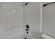 Bright bathroom featuring a shower and tub combo with tiled walls and modern, matte-black fixtures at 1102 Tony Valley Se Dr, Conyers, GA 30013