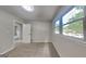 Cozy bedroom showcasing a large window for natural light and neutral carpeting in a freshly painted room at 1102 Tony Valley Se Dr, Conyers, GA 30013