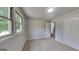 Light-filled bedroom with neutral carpeting, large windows, a closet, and a freshly painted interior at 1102 Tony Valley Se Dr, Conyers, GA 30013