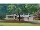 Charming home with a well-maintained lawn, mature trees, and a two-car garage at 1102 Tony Valley Se Dr, Conyers, GA 30013
