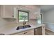 The modern kitchen has white cabinets, stainless appliances, and a double basin sink at 1102 Tony Valley Se Dr, Conyers, GA 30013