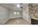 Bright living room featuring a stone fireplace, ceiling fan, and neutral wall color at 1102 Tony Valley Se Dr, Conyers, GA 30013