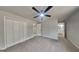 The main bedroom has carpeting, closet, and neutral paint, complemented by a ceiling fan at 1102 Tony Valley Se Dr, Conyers, GA 30013