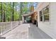 Large outdoor deck surrounded by trees offers an outdoor space for gatherings and relaxation at 145 Oxford Ln, Fayetteville, GA 30215