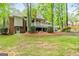 Spacious backyard with a multi-level deck and mature trees, perfect for outdoor activities at 145 Oxford Ln, Fayetteville, GA 30215