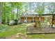 Well-maintained backyard featuring a playset, lush lawn, and a welcoming patio area at 145 Oxford Ln, Fayetteville, GA 30215