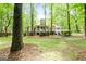 Picturesque backyard featuring a multi-level deck, mature trees, and lush landscaping at 145 Oxford Ln, Fayetteville, GA 30215