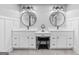 Elegant bathroom with dual vanities, round mirrors, and contemporary fixtures at 145 Oxford Ln, Fayetteville, GA 30215