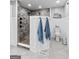 Bright bathroom featuring wainscoting, a toilet, and shower with stone tile at 145 Oxford Ln, Fayetteville, GA 30215