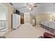 Spacious bedroom with neutral carpet, a ceiling fan, and plenty of storage at 145 Oxford Ln, Fayetteville, GA 30215