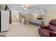 Spacious bedroom with neutral carpet, a ceiling fan, and an abundance of storage at 145 Oxford Ln, Fayetteville, GA 30215