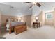 Bedroom featuring vaulted ceiling, ceiling fan, a bed and a side table at 145 Oxford Ln, Fayetteville, GA 30215