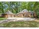 Stunning brick home with a well-manicured lawn and a long driveway leading to an attached two car garage at 145 Oxford Ln, Fayetteville, GA 30215