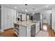 Open kitchen with a large island, seating, and stainless steel appliances at 145 Oxford Ln, Fayetteville, GA 30215
