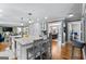 Open concept kitchen with island seating and a view into the living room at 145 Oxford Ln, Fayetteville, GA 30215