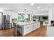 Spacious kitchen with an island, stainless steel appliances, and wood floors at 145 Oxford Ln, Fayetteville, GA 30215