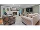 Relaxing living room featuring a painted brick fireplace, comfortable sofas, and a modern television at 145 Oxford Ln, Fayetteville, GA 30215