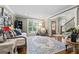 Cozy living room featuring hardwood floors, large windows, and a stylish area rug at 145 Oxford Ln, Fayetteville, GA 30215