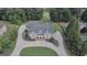 Stunning aerial view of a grand brick home with mature landscaping and circular driveway at 205 Somerset Ct, Mcdonough, GA 30253