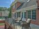 Brick home with outdoor seating on a raised terrace at 205 Somerset Ct, Mcdonough, GA 30253