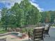 Outdoor seating on a raised terrace overlooking pool and landscaped yard at 205 Somerset Ct, Mcdonough, GA 30253