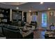 Spacious basement with a fireplace, black leather seating, and walkout access at 205 Somerset Ct, Mcdonough, GA 30253
