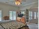 This bedroom has windows with a view and access to the second floor hallway at 205 Somerset Ct, Mcdonough, GA 30253