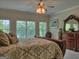 Bright bedroom features a large dresser with mirror and a lovely backyard view at 205 Somerset Ct, Mcdonough, GA 30253