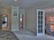Bright bedroom provides hallway access and view of staircase and chandelier at 205 Somerset Ct, Mcdonough, GA 30253