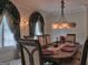 Elegant dining room features decorative window treatments, a chandelier, and seating for six at 205 Somerset Ct, Mcdonough, GA 30253