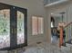 Bright foyer with marble floors, ornate front doors, and views of the dining room at 205 Somerset Ct, Mcdonough, GA 30253