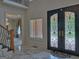 Welcoming foyer featuring marble floors, an ornate front door, and views into the home's elegant interior at 205 Somerset Ct, Mcdonough, GA 30253