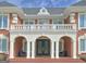 Grand front entrance with stately columns, a balcony, and double doors, creating a luxurious first impression at 205 Somerset Ct, Mcdonough, GA 30253