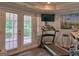 Home gym with a treadmill and natural light from the double doors at 205 Somerset Ct, Mcdonough, GA 30253