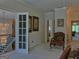 Bright hallway features an ornate staircase and chandelier, and a comfortable chair at 205 Somerset Ct, Mcdonough, GA 30253