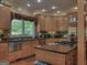 Spacious kitchen featuring stainless steel appliances, wood cabinetry, and a large window at 205 Somerset Ct, Mcdonough, GA 30253