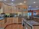 Updated kitchen with stainless steel appliances, wood cabinets, and an open layout at 205 Somerset Ct, Mcdonough, GA 30253