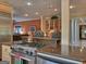 Gourmet kitchen with eat in breakfast bar open to the living room with built in cabinetry at 205 Somerset Ct, Mcdonough, GA 30253