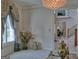 Bright sitting room with a crystal chandelier, ornate decor, and views leading to the main foyer at 205 Somerset Ct, Mcdonough, GA 30253