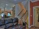 View of the staircase and open concept kitchen from the cozy living room space at 205 Somerset Ct, Mcdonough, GA 30253