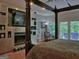 Spacious main bedroom featuring a fireplace, television, and direct access to the outdoor patio at 205 Somerset Ct, Mcdonough, GA 30253
