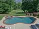 Inground pool with built-in spa and lounge chairs overlooking golf course at 205 Somerset Ct, Mcdonough, GA 30253