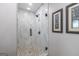 Elegant bathroom with a glass-enclosed shower, decorative mosaic tile floor, and neutral wall art at 111 S Old 27, Roopville, GA 30170