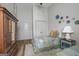 Neutral bedroom features two twin beds, a wooden armoire, and light wood flooring at 111 S Old 27, Roopville, GA 30170