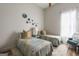Cozy bedroom with twin beds, decorative wall art, and a brightly lit window at 111 S Old 27, Roopville, GA 30170