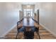 Bright dining room with a long wooden table, black chairs, and modern chandelier at 111 S Old 27, Roopville, GA 30170
