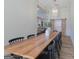 Open dining room with a long wooden table, black chairs, and sliding barn doors at 111 S Old 27, Roopville, GA 30170