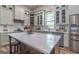 Updated kitchen with an island, quartz countertops, modern appliances, and open shelving at 111 S Old 27, Roopville, GA 30170