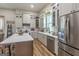 Bright kitchen with an island, stainless steel appliances, and ample storage at 111 S Old 27, Roopville, GA 30170