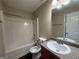 Well-lit bathroom with a shower-tub combo, vanity, and mirror at 257 Juliet Dr, Hampton, GA 30228